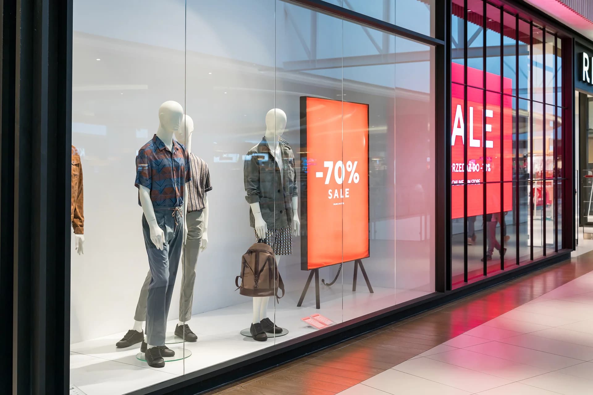 modern storefront of a clothing store with floor to ceiling windows